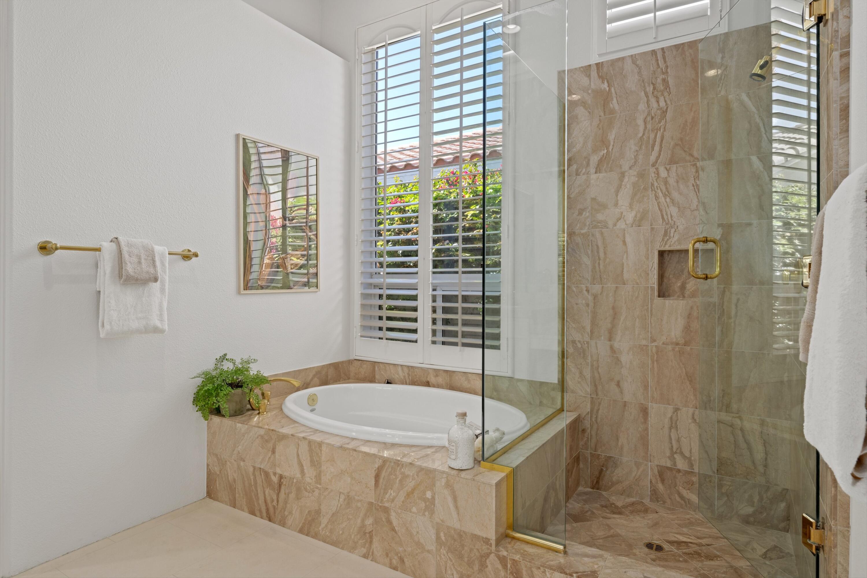 81100 Legends Way La Quinta, CA 92253 - Photo 31 of 37 a bathroom with a tub and shower