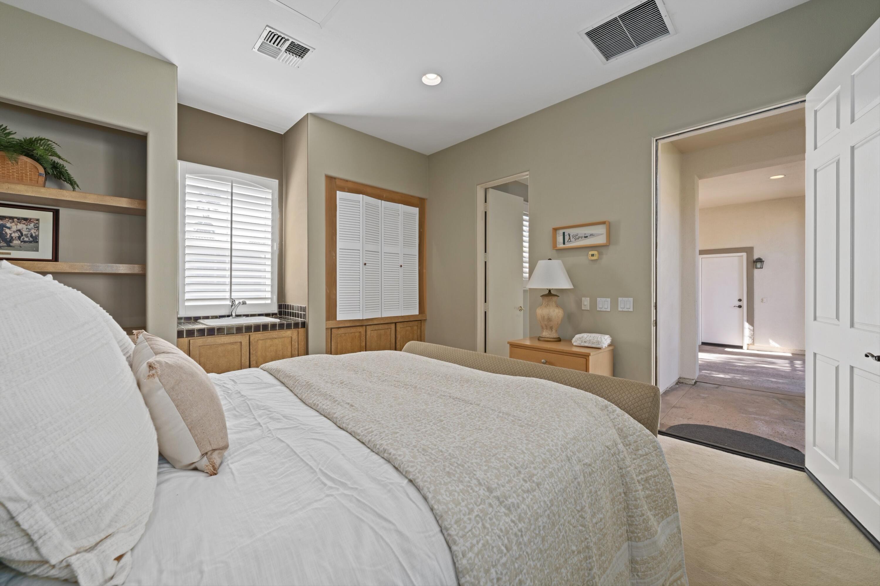 81100 Legends Way La Quinta, CA 92253 - Photo 36 of 37 a bedroom with a bed and large windows