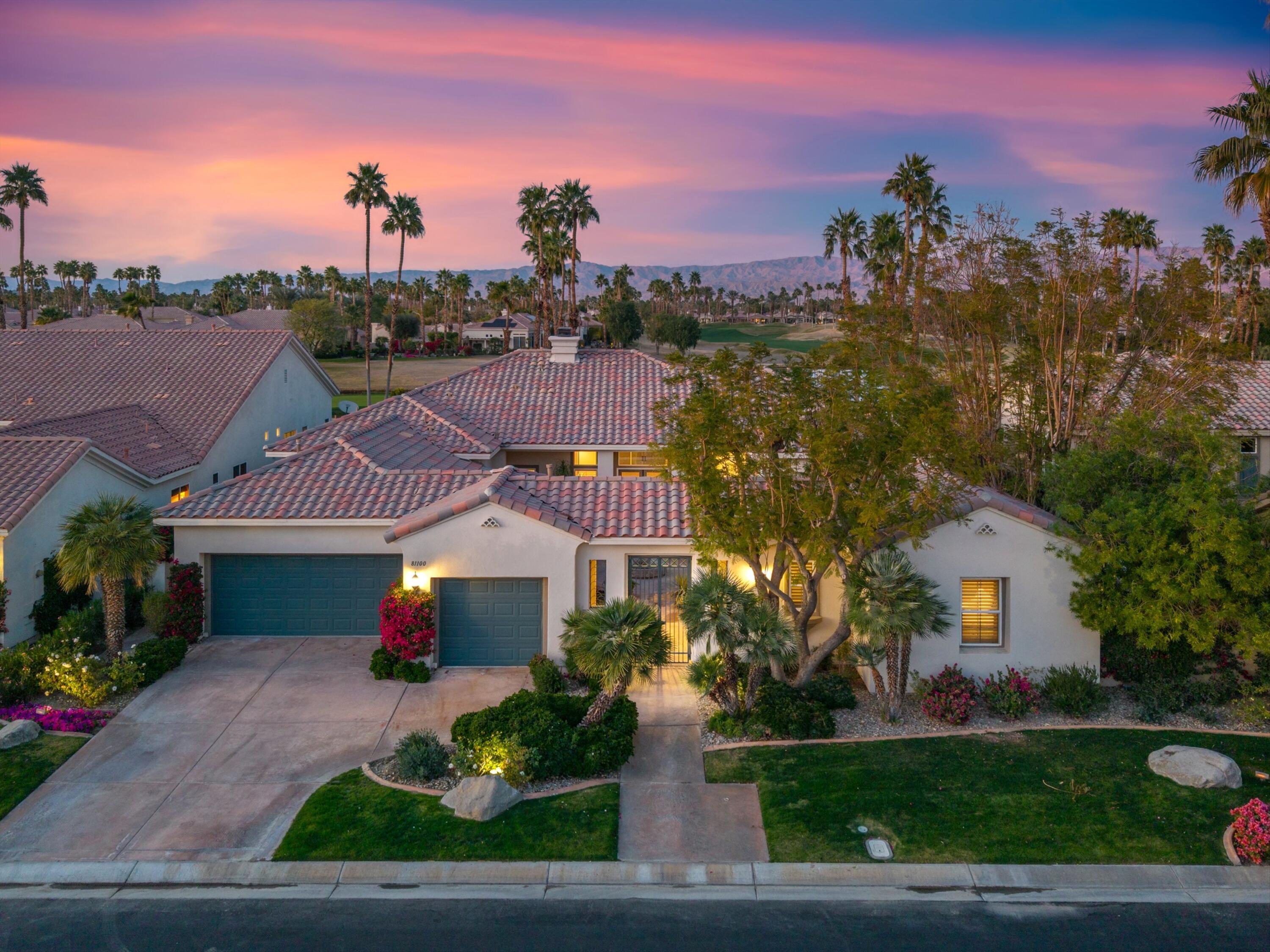 81100 Legends Way La Quinta, CA 92253 - Photo 6 of 37 a front view of a house with a garden and a yard