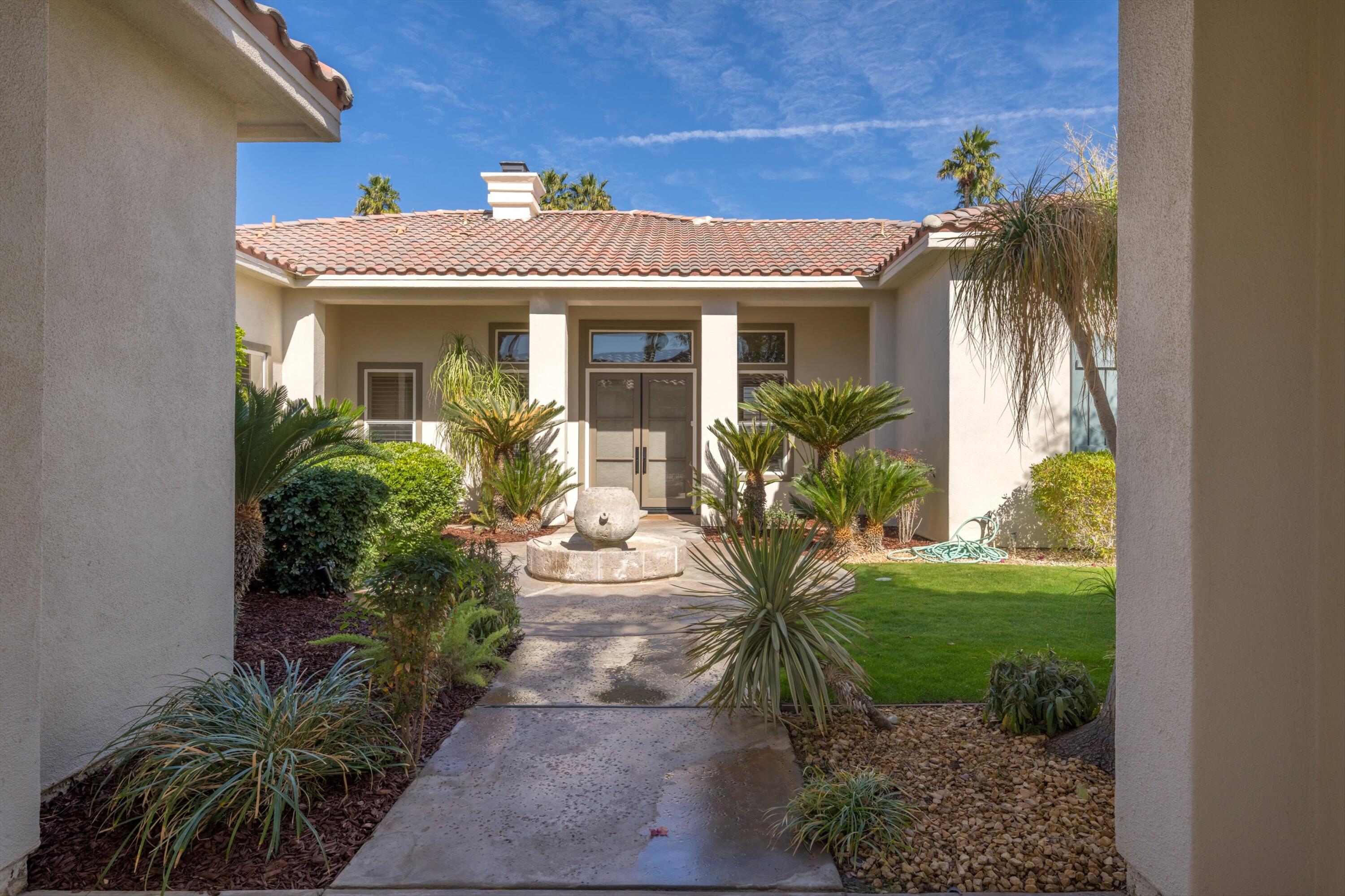 81100 Legends Way La Quinta, CA 92253 - Photo 8 of 37 a front view of a house with a yard