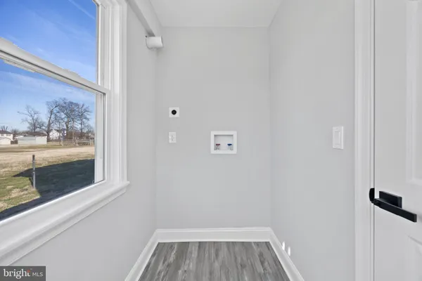 a view of a small space with wooden floor and a window