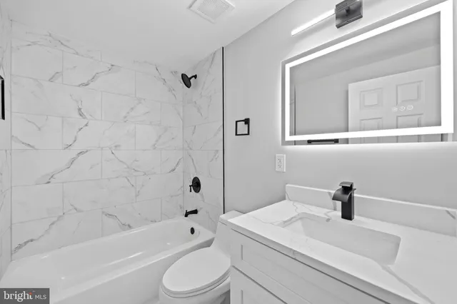 a bathroom with a sink a toilet and a bathtub