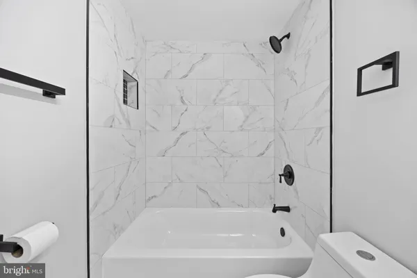 a bathroom with a bathtub and a toilet