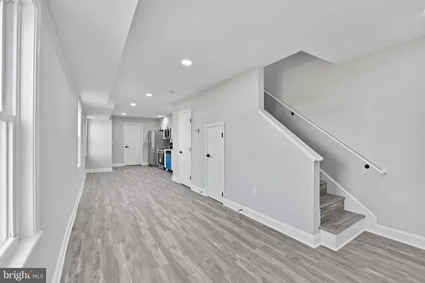 a view of a hallway with wooden floor