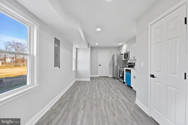 a view of empty room with wooden floor