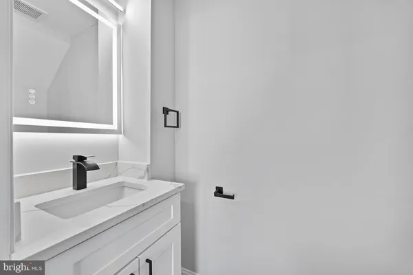 a bathroom with a sink and vanity