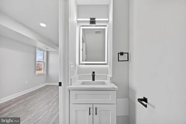 a bathroom with a sink a window and a mirror
