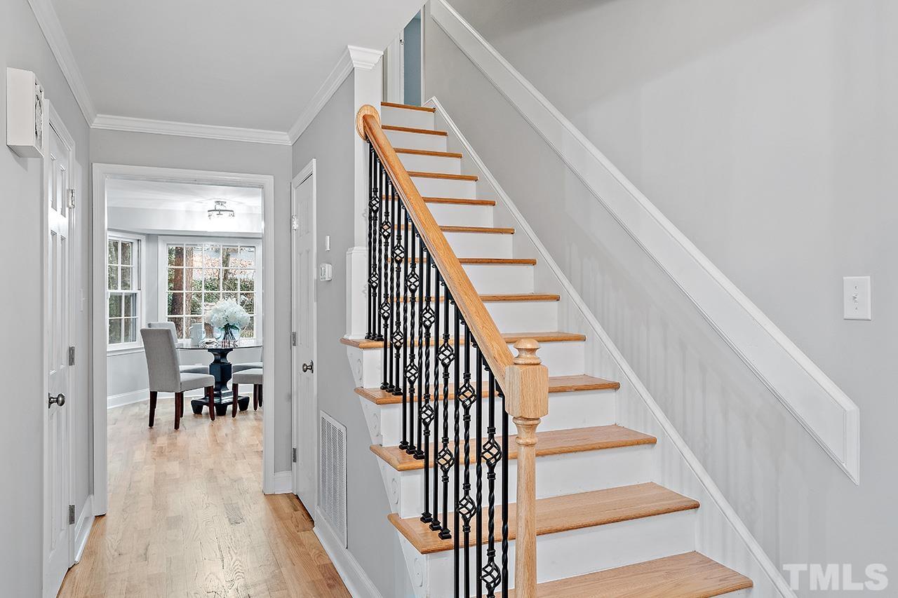 2800 Pidgeon Hill Road Raleigh, NC 27613 - Photo 17 of 35 a view of a hallway with wooden floor staircase and living room