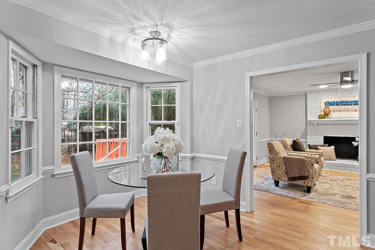 2800 Pidgeon Hill Road Raleigh, NC 27613 - Photo 5 of 35 a dining room with furniture a chandelier and wooden floor