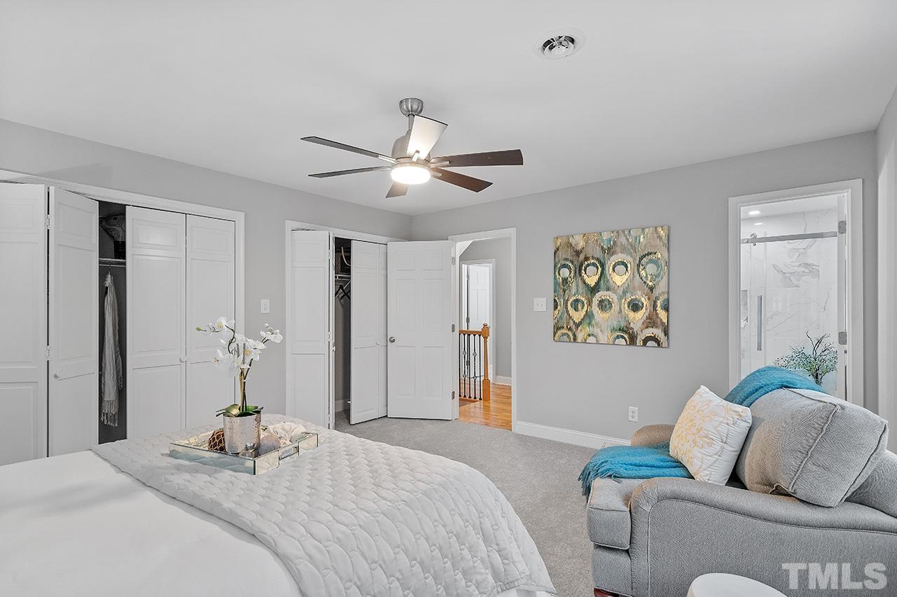 2800 Pidgeon Hill Road Raleigh, NC 27613 - Photo 6 of 35 a bedroom with a bed and a chandelier