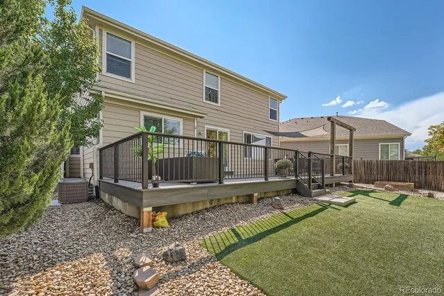 a view of a house with backyard and sitting area