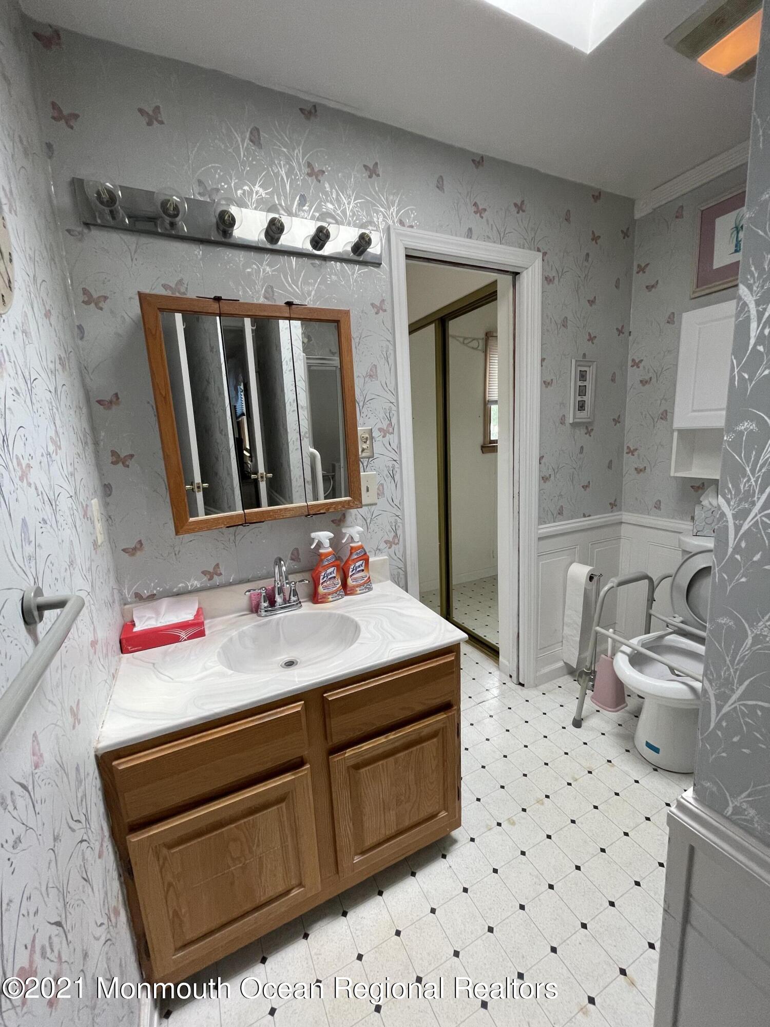 84 Club House Road Brick, NJ 08723 - Photo 12 of 28 a bathroom with a sink vanity granite and a mirror