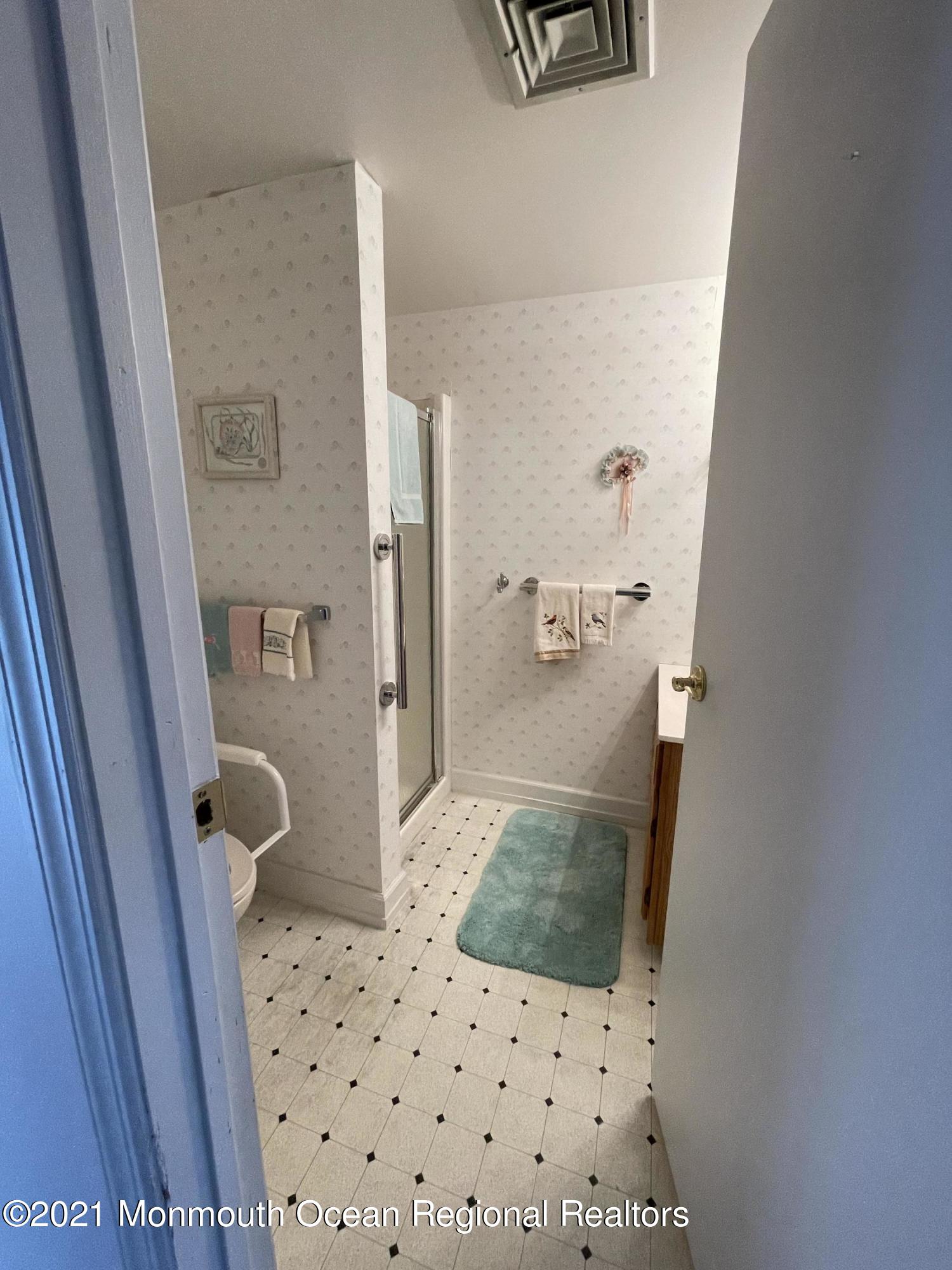 84 Club House Road Brick, NJ 08723 - Photo 15 of 28 a bathroom with a sink and mirror with toilet