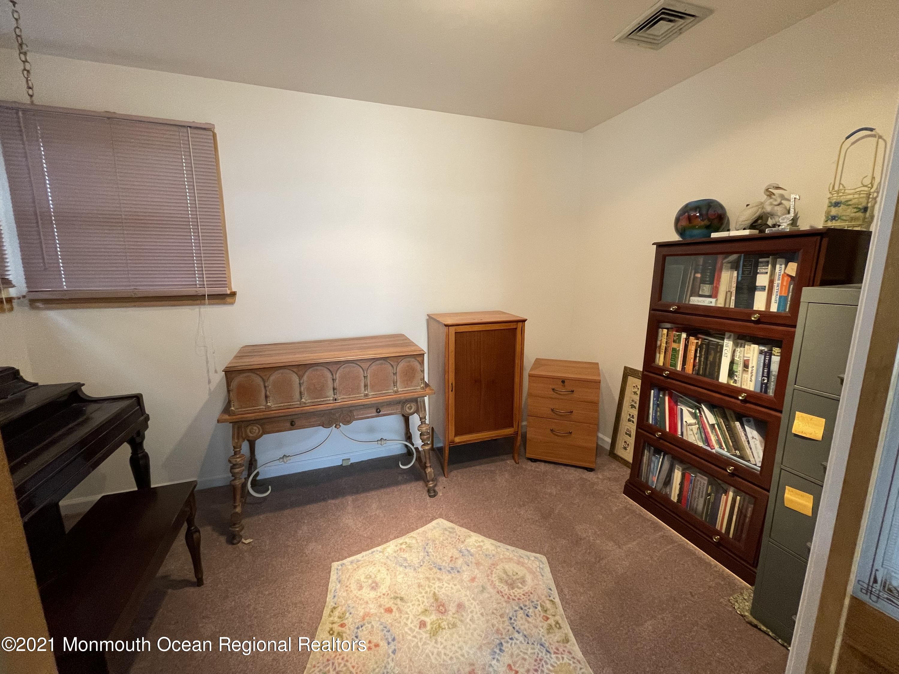 84 Club House Road Brick, NJ 08723 - Photo 17 of 28 a bedroom with a bed and a book shelf
