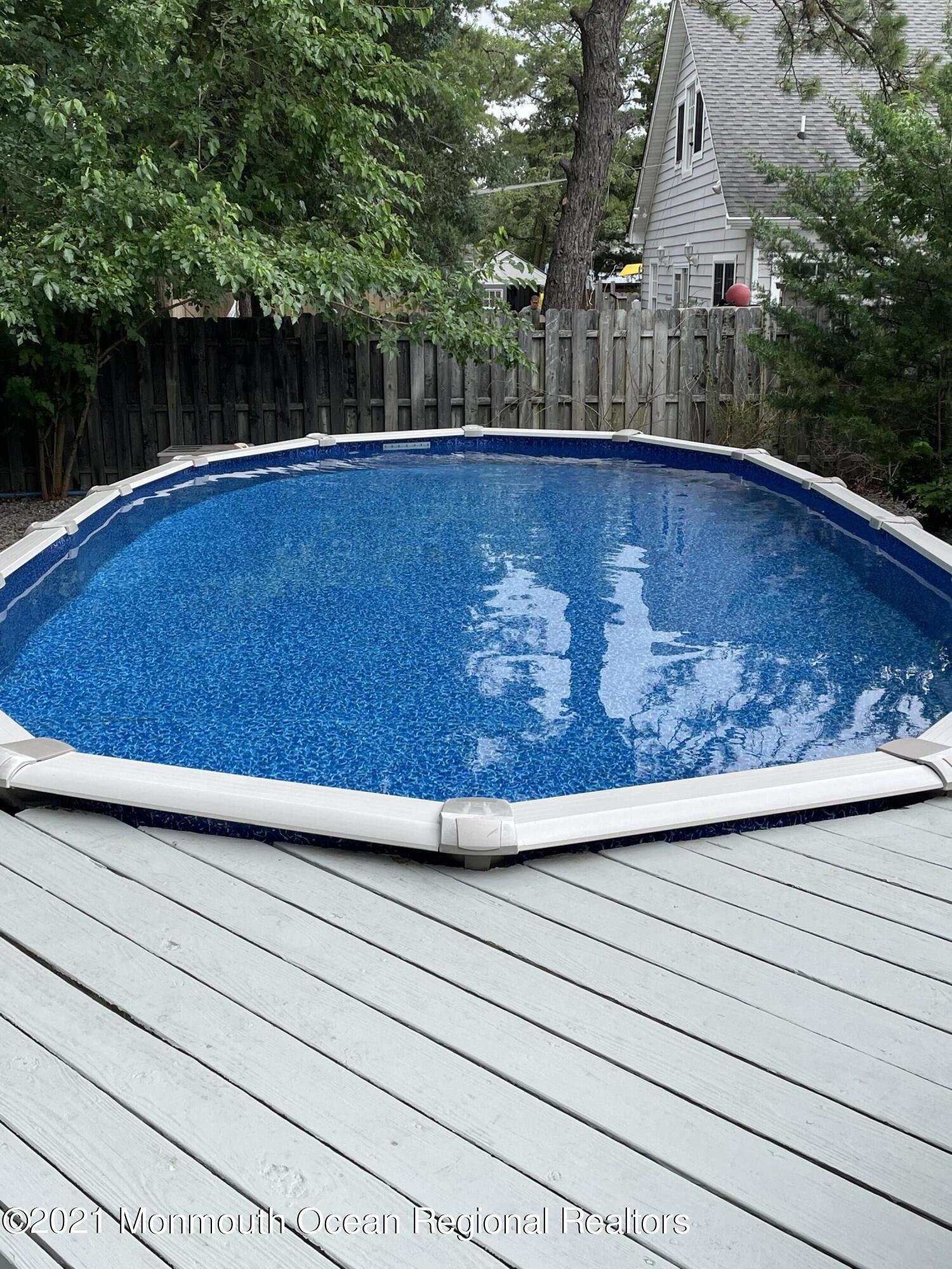 84 Club House Road Brick, NJ 08723 - Photo 24 of 28 a view of a swimming pool with a yard