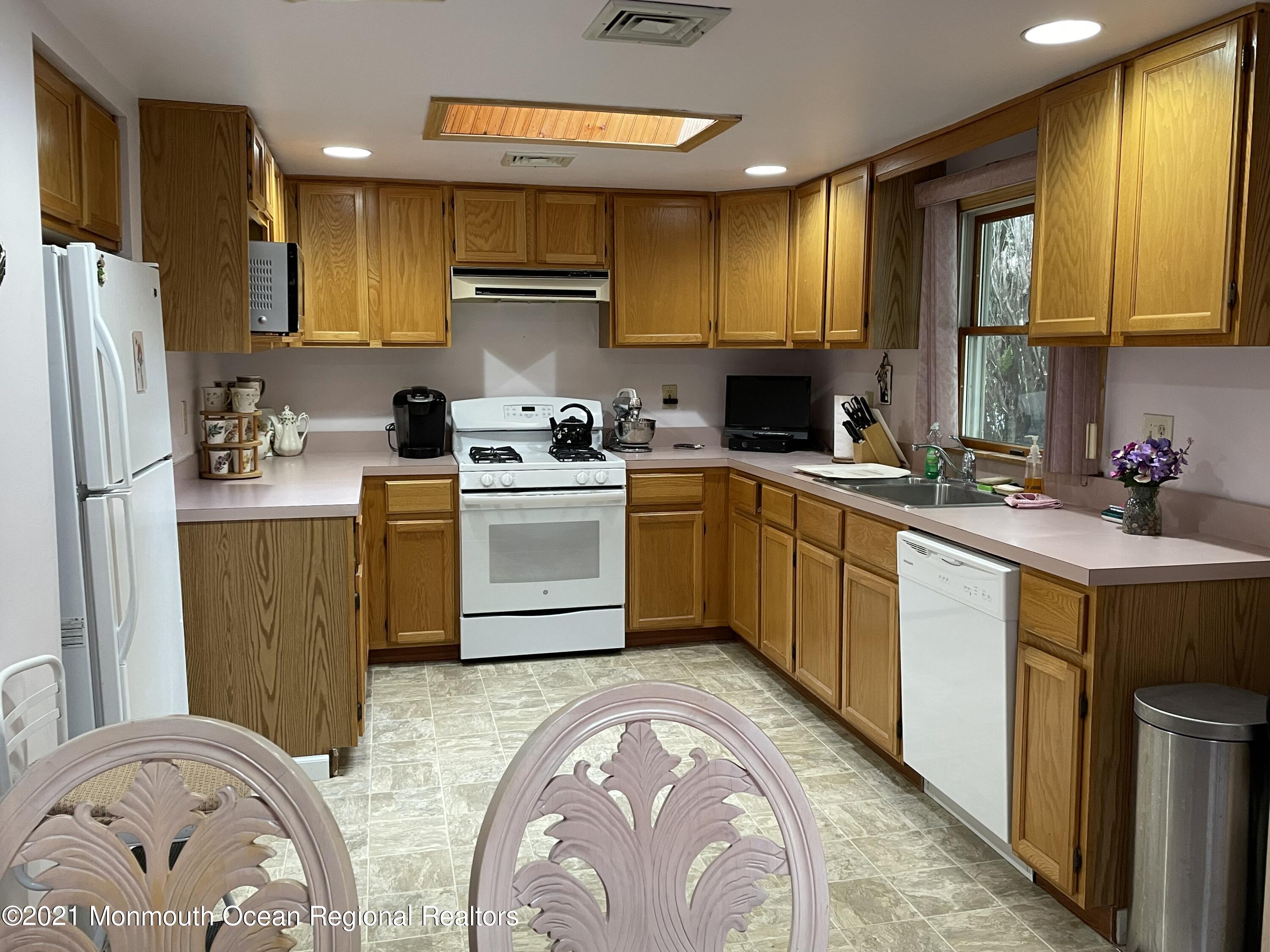 84 Club House Road Brick, NJ 08723 - Photo 8 of 28 a kitchen with a sink a stove cabinets and stainless steel appliances