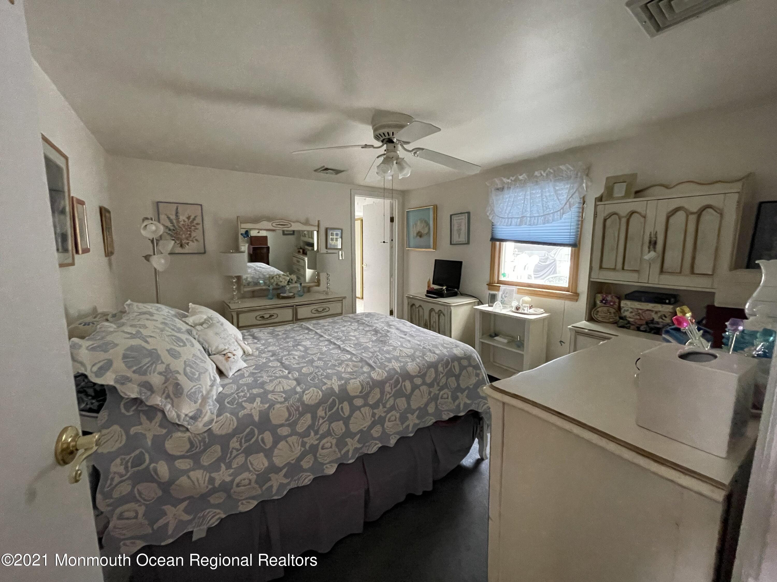 84 Club House Road Brick, NJ 08723 - Photo 10 of 28 a bed room with a bed and a television