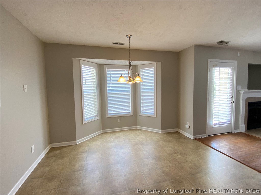 58 Polk Street Spring Lake, NC 28390 - Photo 9 of 26 wooden floor in an empty room with a window