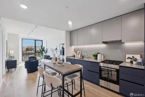 a kitchen with a table chairs stove and cabinets