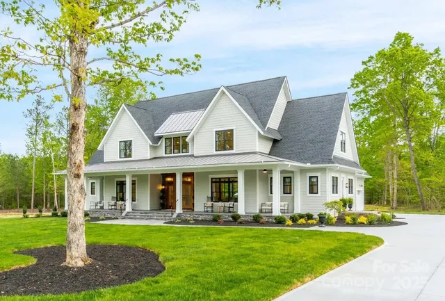a front view of a house with swimming pool and garden