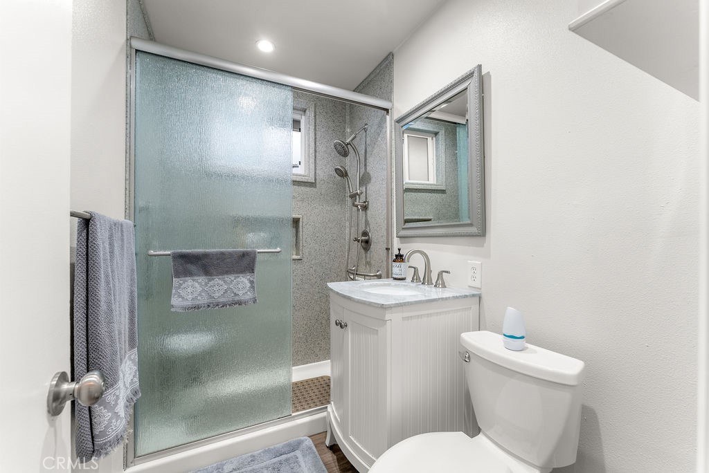 3540 Cannes Avenue Riverside, CA 92501 - Photo 12 of 32 a bathroom with a toilet sink and mirror