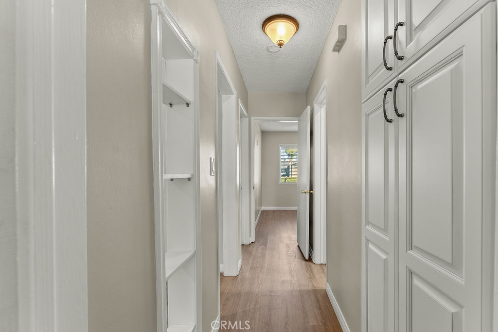 3540 Cannes Avenue Riverside, CA 92501 - Photo 14 of 32 a view of hallway with wooden floor