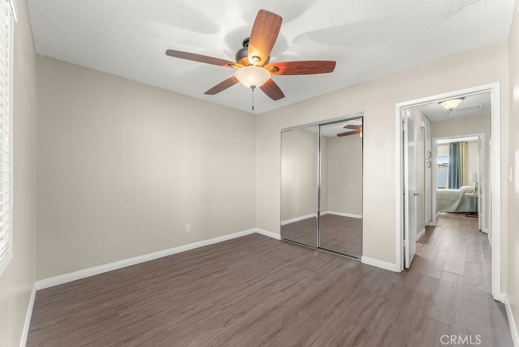 3540 Cannes Avenue Riverside, CA 92501 - Photo 15 of 32 an empty room with wooden floor a ceiling fan and a window