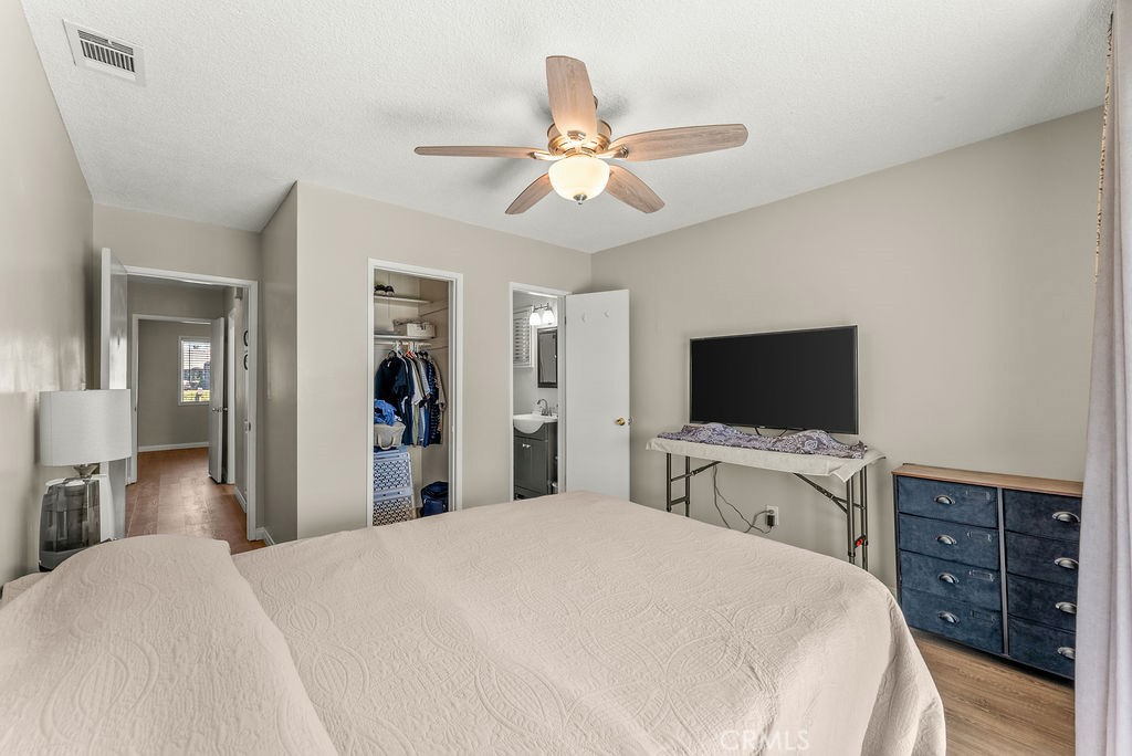 3540 Cannes Avenue Riverside, CA 92501 - Photo 22 of 32 a bedroom with a bed and a flat tv screen on dresser