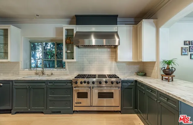 a kitchen with a sink and stove