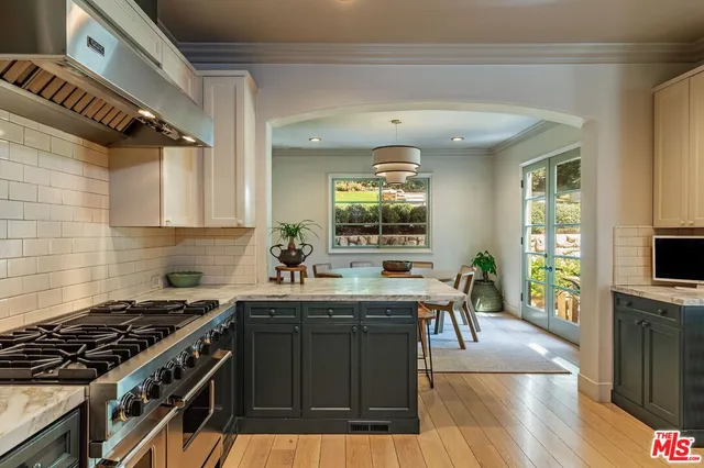 a kitchen with lots of counter top space and wooden floor