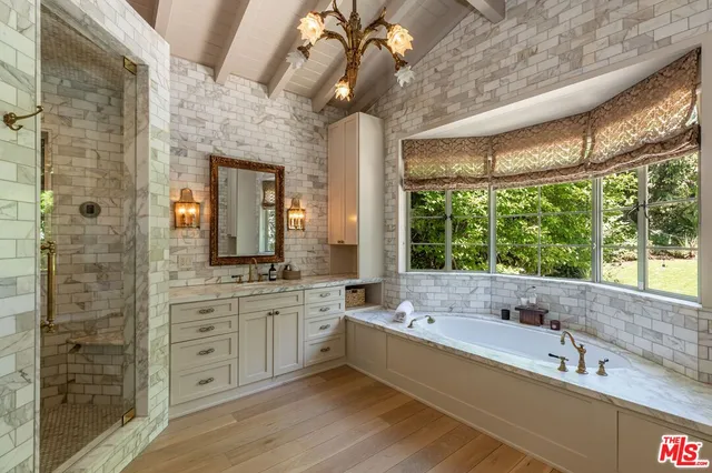 a large bathroom with a large tub and sink