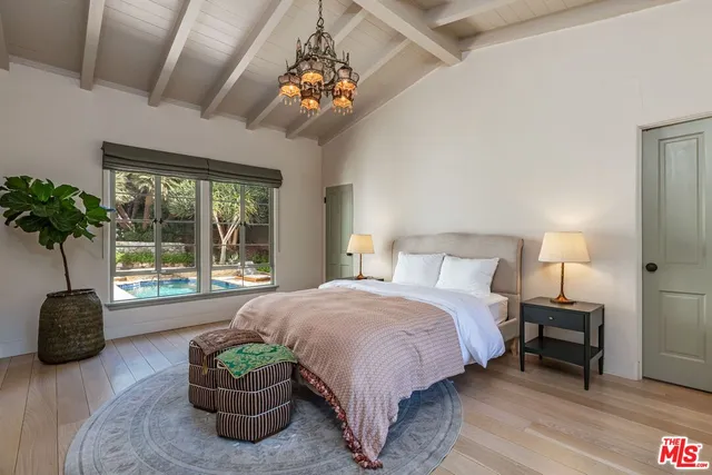 a spacious bedroom with a bed and a large window