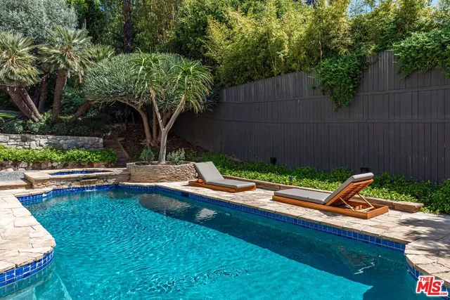 a small pool with outdoor seating and yard