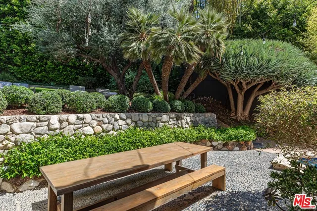 a view of a wooden bench in the backyard