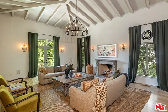a living room with furniture and a chandelier