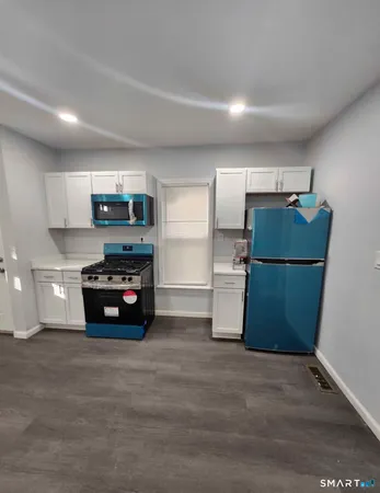 a kitchen with refrigerator and microwave