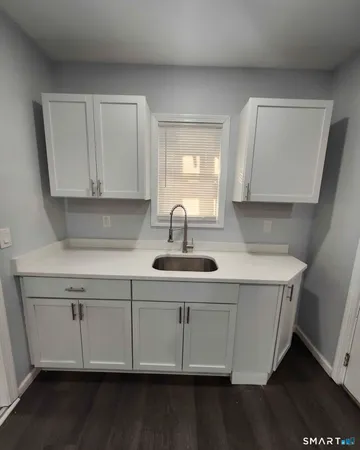 a kitchen with a sink and cabinets