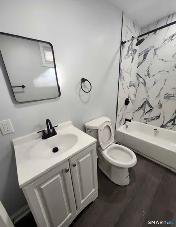a bathroom with a sink toilet and tub