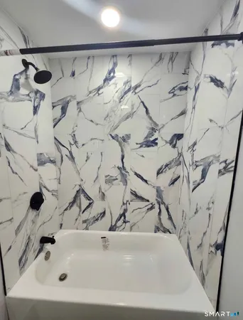 a bathroom with a bathtub and shower