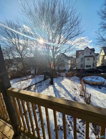 a view of a porch with furniture and wooden fence