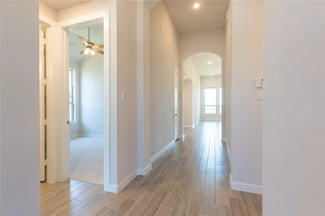 a view of a hallway with wooden floor