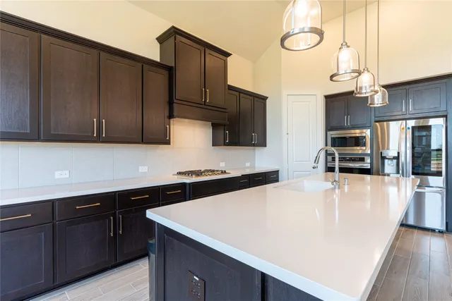 a kitchen with wooden cabinets and white appliances