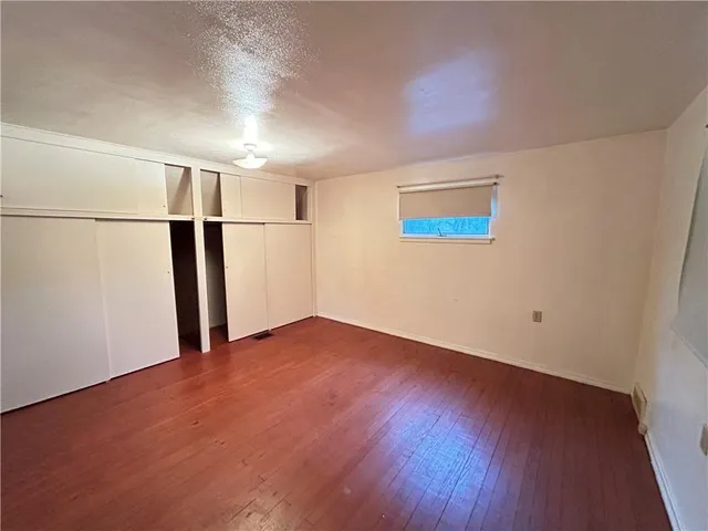 an empty room with wooden floor