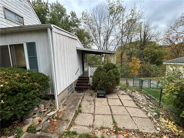 a view of backyard of house with potted plants