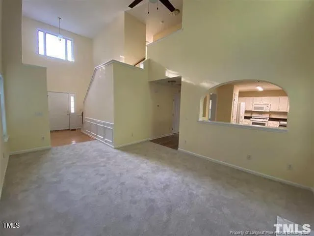 an empty room with windows and entrance