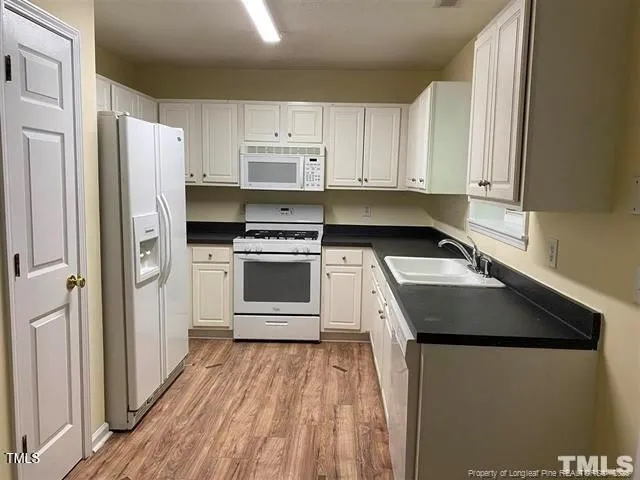 a kitchen with a sink stove and refrigerator