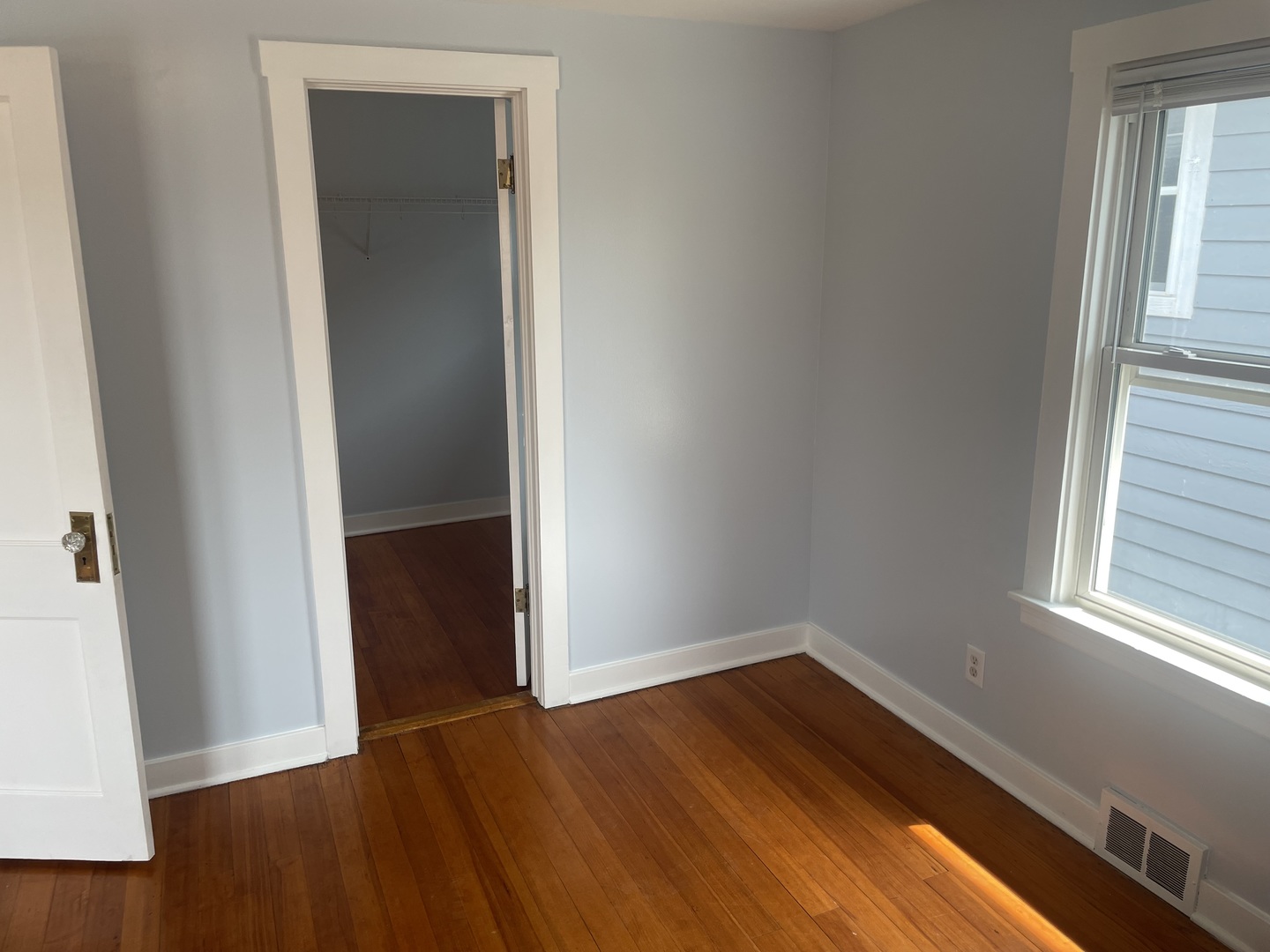 Undisclosed Address Forest Park, IL 60130 - Photo 11 of 16 an empty room with wooden floor and windows