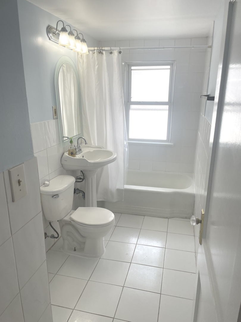 Undisclosed Address Forest Park, IL 60130 - Photo 14 of 16 a bathroom with a toilet sink and window