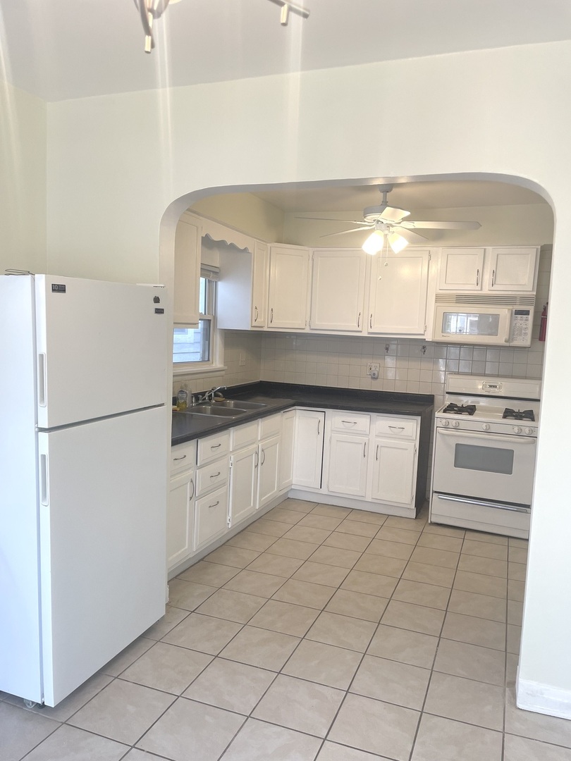 Undisclosed Address Forest Park, IL 60130 - Photo 9 of 16 a kitchen with a refrigerator sink and cabinets