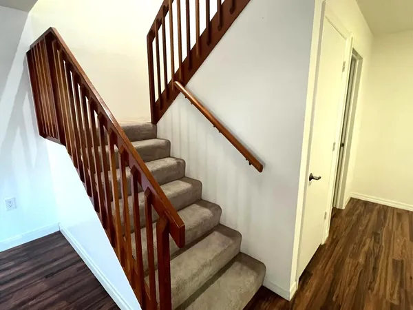 a view of entryway with wooden floor and stairs